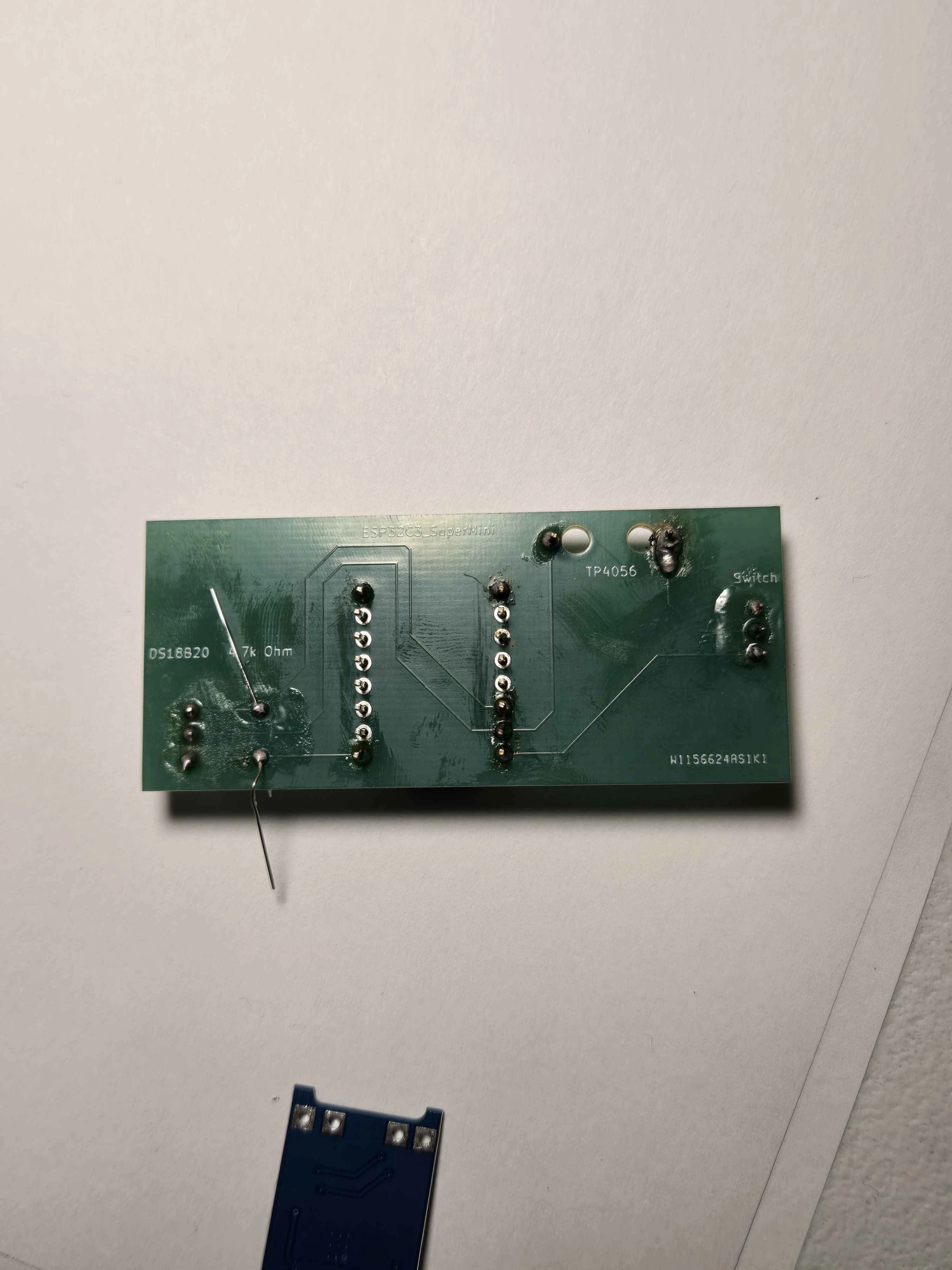 Switch, resistor, and DS18B20 connector soldered on the trace side